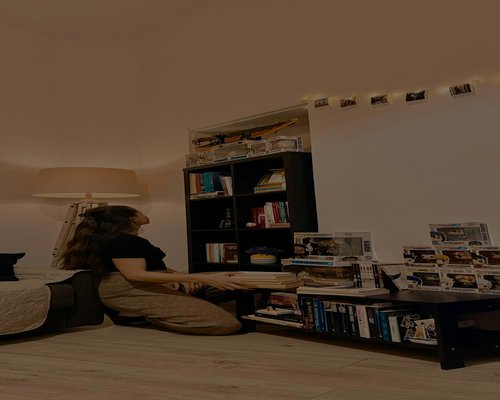 A person adjusting their computer station inside a modern home library setup for absolute comfort